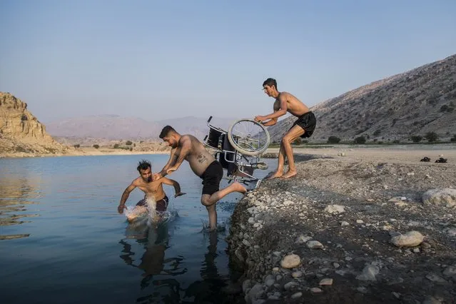 In this image released by World Press Photo, Thursday April 15, 2021, by Fereshteh Eslahi, Podium Photos, titled Thoughts of Flight, part of a series which won third prize in the Sports Stories category, shows Saeed Ramin, a professional traceur (practitioner of parkour) enjoys time with friends at Kosar Dam Lake, near Gachsaran, Iran, on Sept. 9, 2020. (Photo by Fereshteh Eslahi, Podium Photos, World Press Photo via AP Photo)