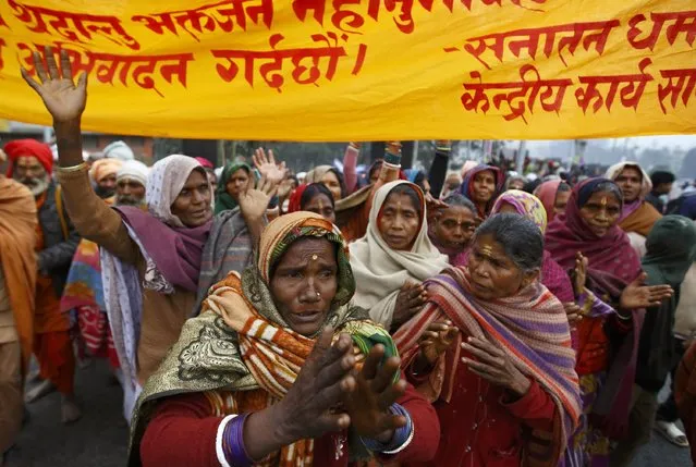 Hindu holy women, or sadhus, chant the name of Lord Shiva as they take part in a religious rally on the premises of Pashupatinath Temple in Kathmandu February 15, 2015. (Photo by Navesh Chitrakar/Reuters)