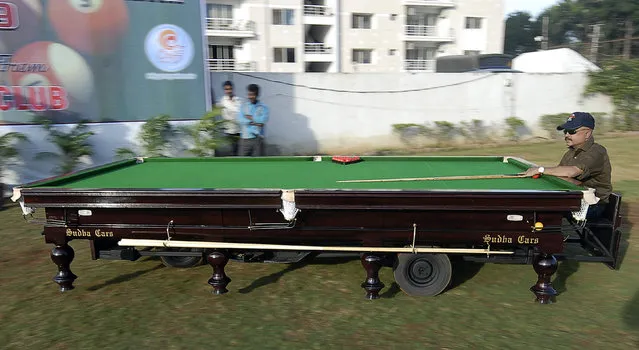 Car designer Sudhakar Yadav drives a car in the shape of a snooker table during a promotional event in Hyderabad November 11, 2009.The car has three wheels with a 150cc engine and it can runs a maximum speed of 45 kph (28 mph). Picture taken November 11, 2009. (Photo by Krishnendu Halder/Reuters)