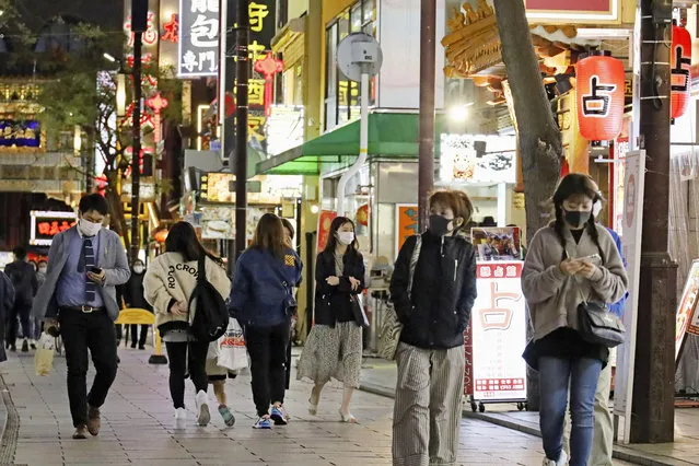 People walk in Chinatown in Yokohama, Kanagawa prefecture, near Tokyo Friday, April 15, 2021. Japan is set to raise the coronavirus alert level in Tokyo’s three neighboring prefectures and a forth area in central Japan to allow tougher measures as a more contagious coronavirus variant spreads and doubts are growing whether the Olympics can go ahead. (Photo by Kyodo News via AP Photo)