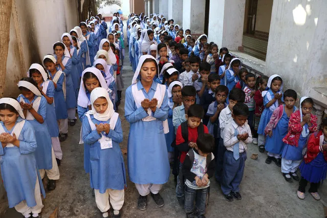 Pakistani school children pray for the victim of PIA plane crash in Abbottabad district in northwest Khyber Pakhtunkhwa province, in Karachi, Pakistan on December 08, 2016. All 48 passengers on board the plane, which crashed north of Pakistani capital, have been killed, chairman of Pakistan International Airlines (PIA) confirmed. (Photo by Sabir Mazhar/Anadolu Agency/Getty Images)