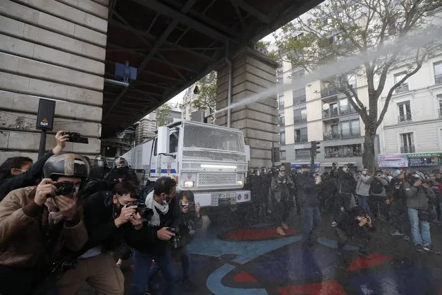 A police water canon vehicle advances during a banned protest in support of Palestinians in the Gaza Strip, in Paris, Saturday, May, 15, 2021. Marches in support of Palestinians in the Gaza Strip were being held Saturday in a dozen French cities, but the focus was on Paris, where riot police got ready as organizers said they would defy a ban on the protest. (Photo by Michel Euler/AP Photo)
