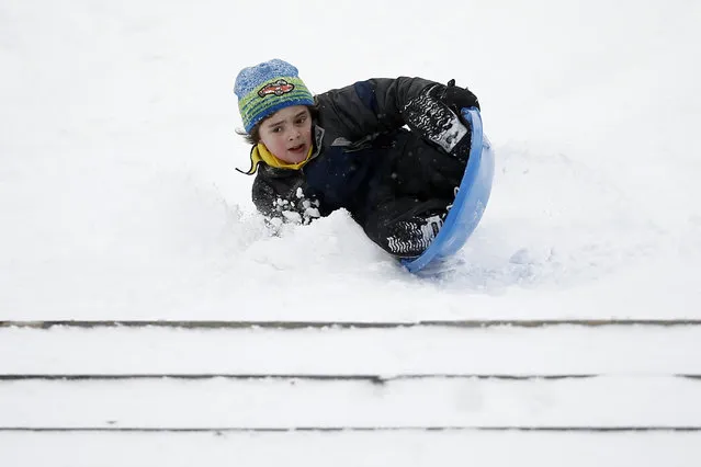 A boy crashes while sledding down the steps of the Philadelphia Museum of Art during a snowstorm, Saturday, January 23, 2016, in Philadelphia. (Photo by Matt Slocum/AP Photo)