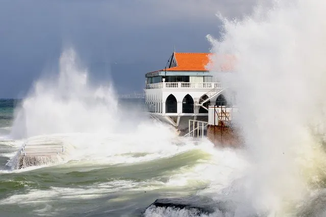 Waves smash against a restaurant building at Beirut's seaside promenade as heavy winds and rain whipped across Lebanon on January 24, 2016. (Photo by Anwar Amro/AFP Photo)