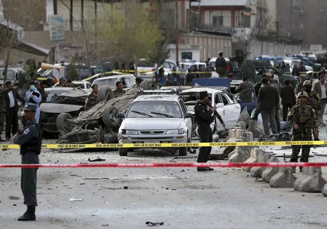 Afghan security forces inspect the site of a suicide attack in Kabul March 25, 2015. (Photo by Omar Sobhani/Reuters)