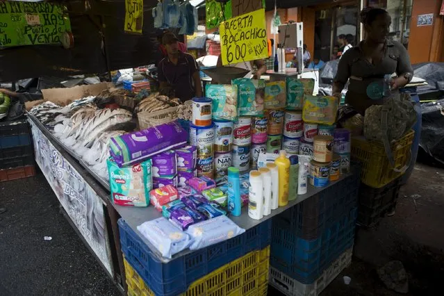 Street vendors sell subsidized goods on a street, at the Petare slum district of Caracas November 9, 2015. Driven by a deepening economic crisis, smuggling across Venezuela's land and maritime borders – as well as illicit domestic trading – has accelerated to unprecedented levels and is transforming society. Although smuggling has a centuries-old history here, the socialist government's generous subsidies and a currency collapse have given it a dramatic new impetus. (Photo by Marco Bello/Reuters)