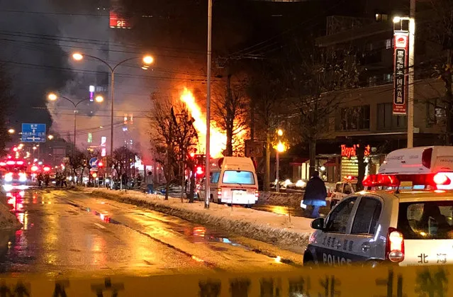 First responders work at the scene of an explosion in Sapporo, Japan, Sunday, December 16, 2018. Dozens of people were injured in the explosion Sunday night at a Japanese restaurant in northern Japan, police said. The explosion occurred in Sapporo, the capital city of Japan's northern main island of Hokkaido, and caused nearby apartment buildings and houses to shake. (Photo by Twitter/@Keibapandra via Reuters)