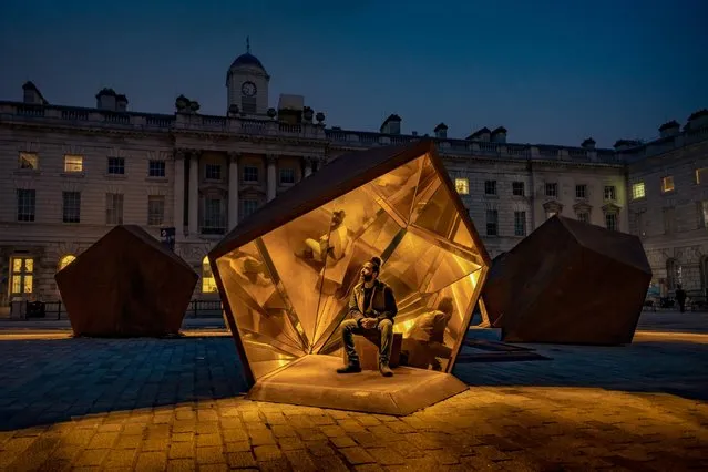 Moroccan artist Amine El Gotaibi rests in his installation “Illuminate the Light” in the courtyard of Somerset House, central London on October 11, 2023. The six sculptures are inspired by the seeds of a pomegranate. (Photo by Guy Corbishley/Alamy Live News)