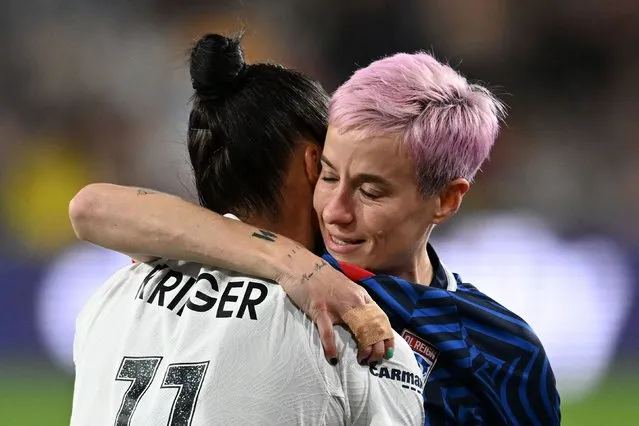 Gotham FC's US defender #11 Ali Krieger hugs OL Reign's US midfielder #15 Megan Rapinoe as she is helped off the pitch after an injury in the early minutes of the first half of the National Women's Soccer League final match between OL Reign and Gotham FC at Snapdragon Stadium in San Diego, California, on November 11, 2023. US women's football icon Megan Rapinoe limped out of the final game of her storied career, suffering an apparent ankle injury less than three minutes into the National Women's Soccer League Final. (Photo by Robyn Beck/AFP Photo)