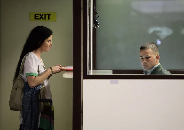 Cuban dissident blogger Yoani Sanchez stands at the immigration control at Havana's Jose Marti International Airport, February 2013. (Photo by Desmond Boylan/Reuters)