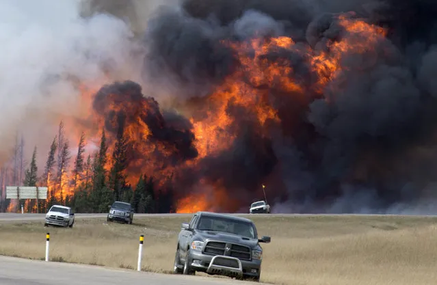 A wildfire burns south of Fort McMurray, Alberta, near Highway 63 on Saturday, May 7, 2016. A book about an inferno that ravaged a Canadian city and has been called a portent of climate chaos has won Britain’s leading nonfiction book prize. John Valliant’s “Fire Weather: A True Story from a Hotter World” was awarded the 50,000 pound ($62,000) Baillie Gifford Prize at a ceremony in London on Thursday, Nov. 16, 2023. (Photo by Jonathan Hayward/The Canadian Press via AP Photo)