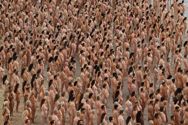 Thousands of people stand nude, as part of an installation by contemporary artist Spencer Tunick, at Bondi Beach in Sydney, Australia 26 November 2022. Thousands of people have bared all for photographer Spencer Tunick at Sydney's Bondi Beach. The shoot aims to remind people to get checked for skin cancer. (Photo by Dean Lewins/EPA/EFE)