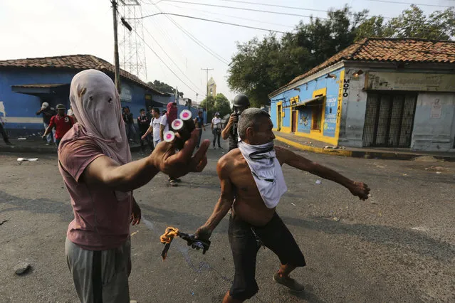 Opposition demonstrators clash with the Bolivarian National Guard in Urena, Venezuela, near the border with Colombia, Saturday, February 23, 2019. (Photo by Fernando Llano/AP Photo)