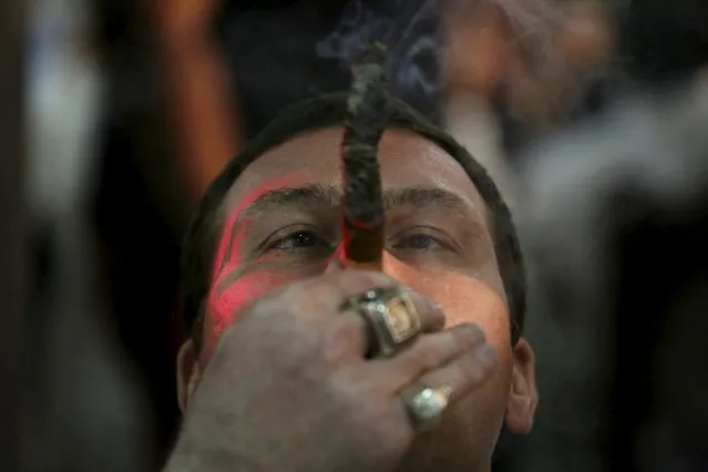 Actor Max Uralsky, from Russia, smokes as he competes for the longest ash during the XVIII Habanos Festival in Havana, March 3, 2016. (Photo by Alexandre Meneghini/Reuters)