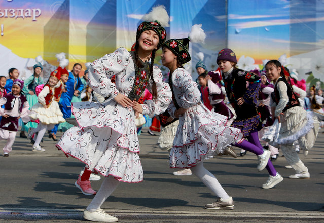 A Kyrgyz girls dressed in a national costume dance during the celebration of Nooruz in Bishkek, Kyrgyzstan, 21 March 2019. Nooruz is traditionally celebrated by Central Asian people as a New Year holiday. (Photo by Igor Kovalenko/EPA/EFE)
