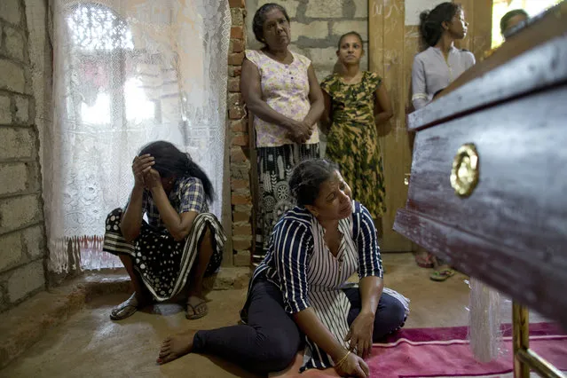 Relatives weep near the coffin with the remains of 12-year Sneha Savindi, who was a victim of Easter Sunday bombing at St. Sebastian Church, after it returned home, Monday, April 22, 2019 in Negombo, Sri Lanka. Easter Sunday bombings of churches, luxury hotels and other sites was Sri Lanka's deadliest violence since a devastating civil war in the South Asian island nation ended a decade ago. (Photo by Gemunu Amarasinghe/AP Photo)