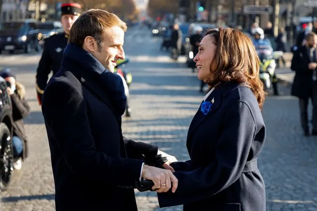 French President Emmanuel Macron speaks to Vice President Kamala Harris before ceremonies marking the 103rd anniversary of Armistice Day, Thursday, November 11, 2021 in Paris. (Photo by Ludovic Marin, Pool via AP Photo)