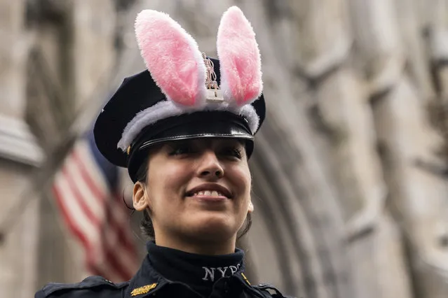 A NYPD officer wears rabbit ears during the Easter Parade and Bonnet Festival, Sunday, April 21, 2019 in New York. (Photo by Jeenah Moon/AP Photo)