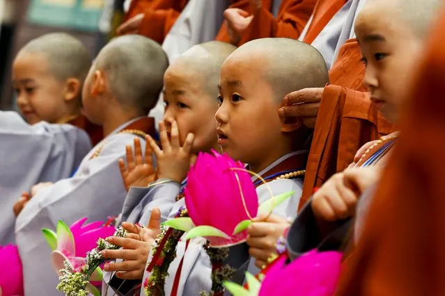 Novice monks line up after an inauguration ceremony at Jogye temple in Seoul, May 11, 2015. (Photo by Thomas Peter/Reuters)