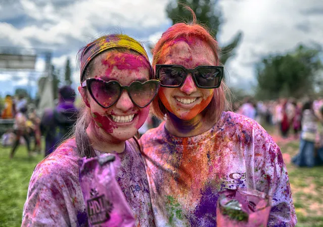 Smeared in colored powder fashionable women wearing sun glasses celebrate Holi, the Hindu festival of colors, in the Encino section of Los Angles on Sunday, March 24, 2024. (Photo by Richard Vogel/AP Photo)