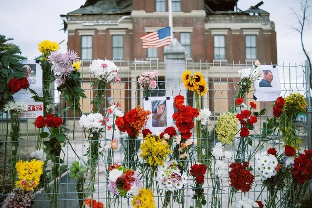 People leave flowers for victims of deadly tornado outside the damaged courthouse in Mayfield, Kentucky, United States on December 15, 2021. (Photo by Joe Bulger/Anadolu Agency via Getty Images)