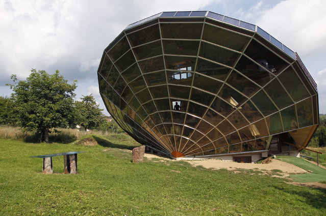 The Heliodome, a bioclimatic solar house is seen in Cosswiller near Strasbourg, eastern France, August 4, 2011. The house is designed as a giant three-dimensional sundial, set on a fixed angle in relationship to the sun's movements to provide shade during the summer months, keeping the inside temperature cool. (Photo by Vincent Kessler/Reuters)