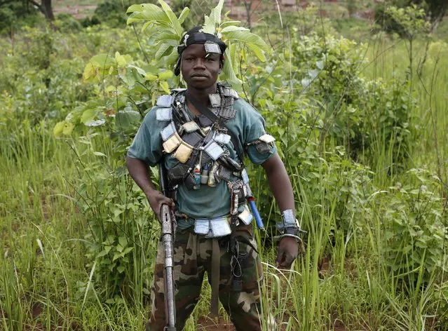 A member of the anti-balaka, a Christian militia, stands during a patrol outside the village of Zawa April 8, 2014. (Photo by Goran Tomasevic/Reuters)