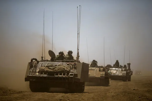 Israeli soldiers drive armored military vehicles during training exercises in the Israeli-occupied Golan Heights, near the border with Syria, Wednesday, June 17, 2015. Syrian rebels launched a wide-ranging offensive against Syrian government positions near the Golan Heights on Wednesday, after tit-for-tat shelling in and around Damascus left at least 33 people dead, activists said. Insurgents have been on the offensive in southern Syria for the past three months, capturing military bases, villages and a border crossing point with Jordan. (AP Photo/Ariel Schalit)