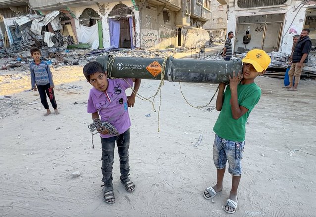 Children are seen playing with US-origin weapons and ammunition that were used by the Israeli Army in the ground operation following their withdrawal from Khan Yunis city where they carried out a ground attack for four months, in Khan Yunis, Gaza on May 16, 2024. Israeli media reported earlier on Sunday, April 7, that the Israeli army withdrew its 98th Division, with its three brigades from Khan Yunis. (Photo by Anas Zeyad Fteha/Anadolu via Getty Images)
