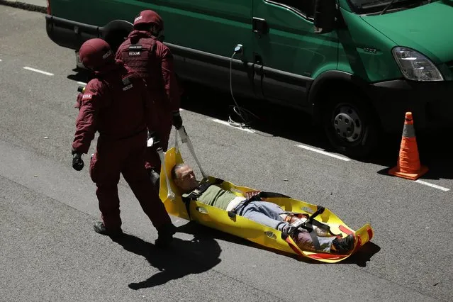 During a training exercise for London's emergency services, a casualty is dragged away by rescue officers from the London Fire Brigade, outside the disused Aldwych underground train station in London, Tuesday, June 30, 2015. (Photo by Matt Dunham/AP Photo)