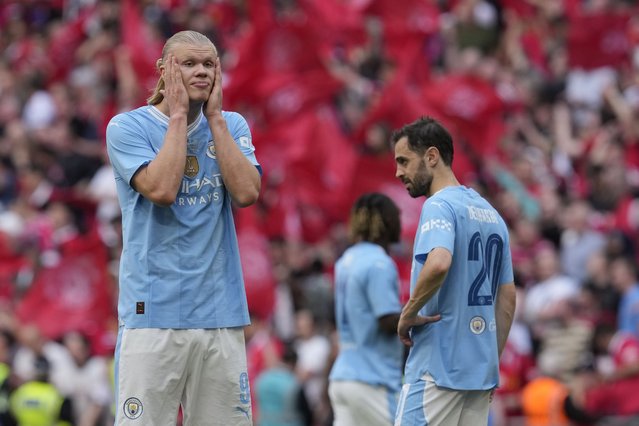 Manchester City's Erling Haaland, left, and Manchester City's Bernardo Silva react at the end of the English FA Cup final soccer match between Manchester City and Manchester United at Wembley Stadium in London, Saturday, May 25, 2024. Manchester United won 2-1. (Photo by Kin Cheung/AP Photo)