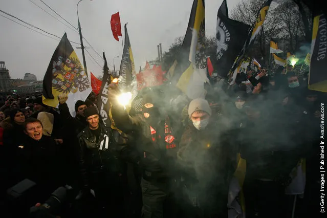 Protesters hold flags and banners aloft as they march in Bolotnaya Square on December 10, 2011 in Moscow, Russia