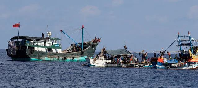 A Chinese fishing vessel is anchored next to Filipino fishing boats at the disputed Scarborough Shoal April 6, 2017. Picture taken April 6, 2017. (Photo by Erik De Castro/Reuters)