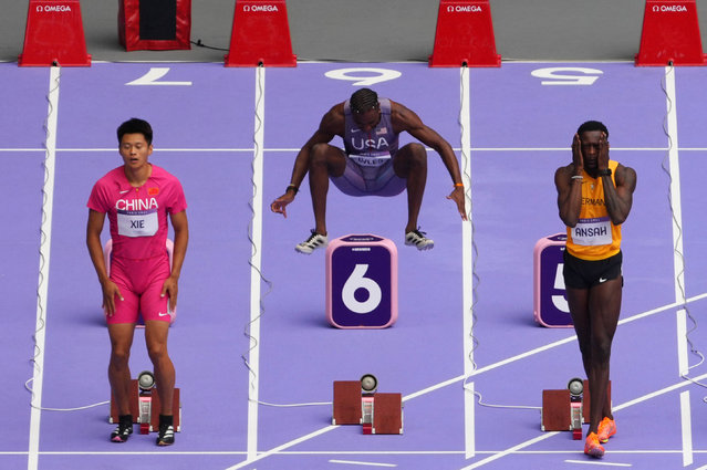 Noah Lyles of the USA takes an athletic leap as he warms up before his 100m sprint heat at Stade de France in Saint-Denis, France on August 03, 2024. (Photo by Aleksandra Szmigiel/Reuters)