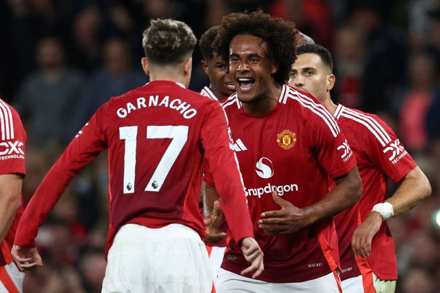 Manchester United's Dutch striker #11 Joshua Zirkzee (R) celebrates with Manchester United's Argentinian midfielder #17 Alejandro Garnacho (L) after scoring the opening goal of the English Premier League football match between Manchester United and Fulham at Old Trafford in Manchester, north west England, on August 16, 2024. (Photo by Darren Staples/AFP Photo)