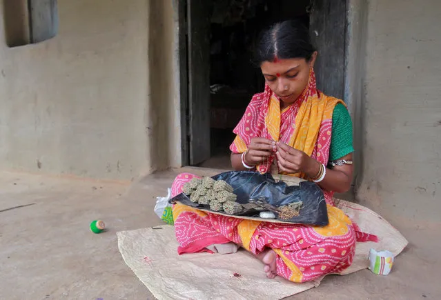 A woman makes bidi or local cigarette hand-rolled with tobacco leaf, on the eve of World No Tobacco Day, in Agartala, India May 30, 2016. (Photo by Jayanta Dey/Reuters)
