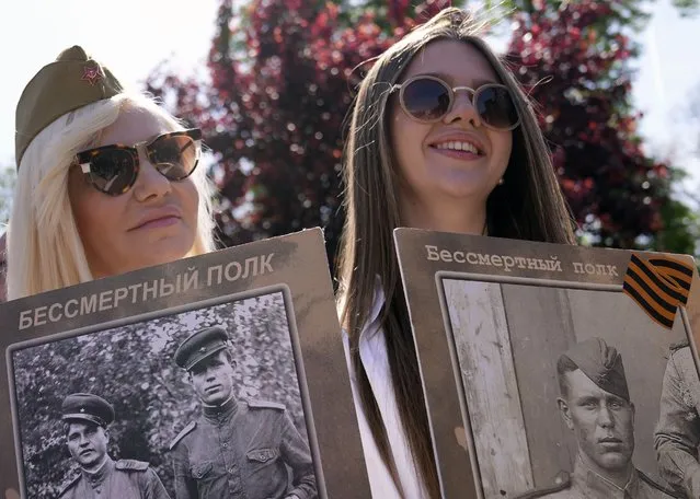 Women hold pictures of relatives killed in WWII, during the Victory Day ceremony in Belgrade, Serbia, Monday, May 9, 2022 on the occasion of the 77th anniversary of the victory over Nazi Germany in WWII. (Photo by Darko Vojinovic/AP Photo)