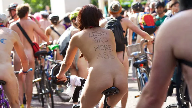 World Naked Bike Ride, London, Britain, 14 June 2014. Hundreds of people riding their bikes naked in London as protest against motor vehicles. (Photo by Andre Camara/Rex Features)