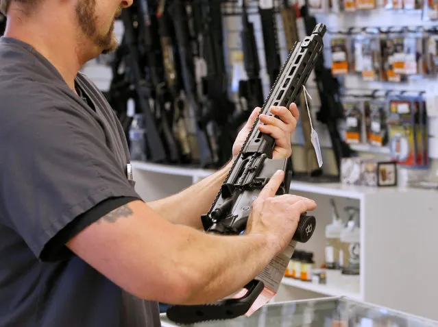 A prospective buyer examines an AR-15 at the “Ready Gunner” gun store in Provo, Utah, U.S., June 21, 2016. (Photo by George Frey/Reuters)