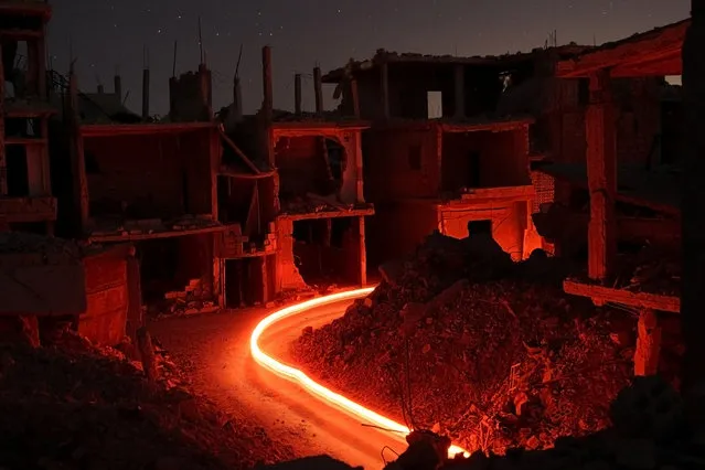 Damaged buildings are pictured at night in the rebel-held area, in the city of Deraa, Syria July 15, 2017. (Photo by Alaa Al-Faqir/Reuters)