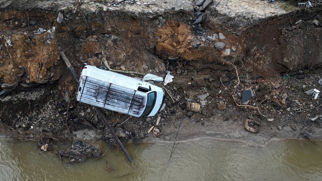 A drone view of a van toppled over on a crumbled embankment along the Swannanoa River after Storm Helene passed through the area, in Swannanoa, North Carolina on October 3, 2024. (Photo by Nathan Frandino/Reuters)