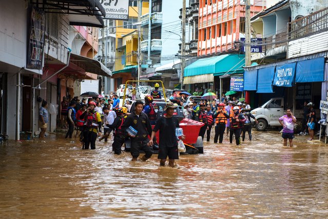 Rescue workers help stranded people from a flooded area at the border town of Mae Sai, following the impact of Typhoon Yagi, in the northern province of Chiang Rai, Thailand on September 11, 2024. (Photo by SZZW/Reuters)