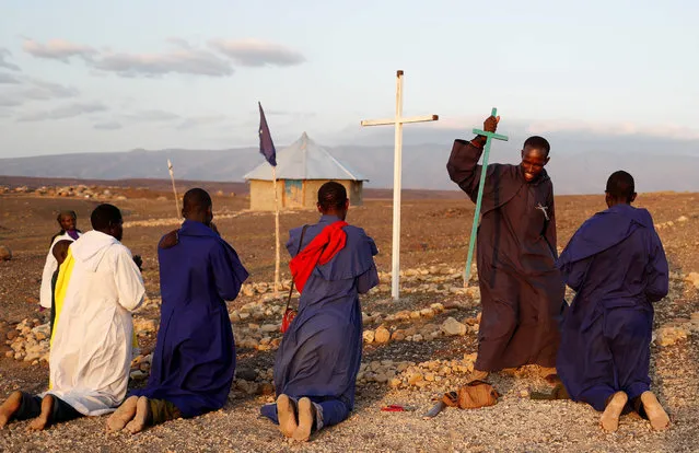 Turkana men pray outside a Legio Maria African Mission Church in Loiyangalani, Kenya August 5, 2017. (Photo by Goran Tomasevic/Reuters)