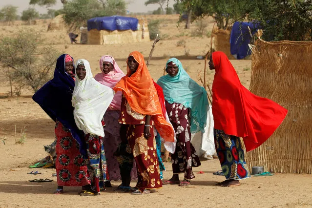 Women stand at a site for displaced persons outside the town of Diffa in southeastern Niger June 19, 2016. (Photo by Luc Gnago/Reuters)