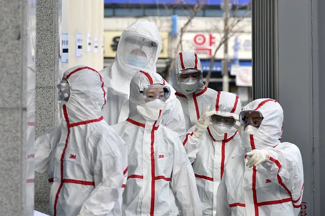 Medical staff members in protective gears arrive for a duty shift at Dongsan Hospital in Daegu, South Korea, Tuesday, March 3, 2020. China's coronavirus caseload continued to wane Tuesday even as the epidemic took a firmer hold beyond Asia, with three countries now exceeding 1,000 cases and the U.S. reporting its sixth death. (Photo by Lee Moo-ryul/Newsis via AP Photo)