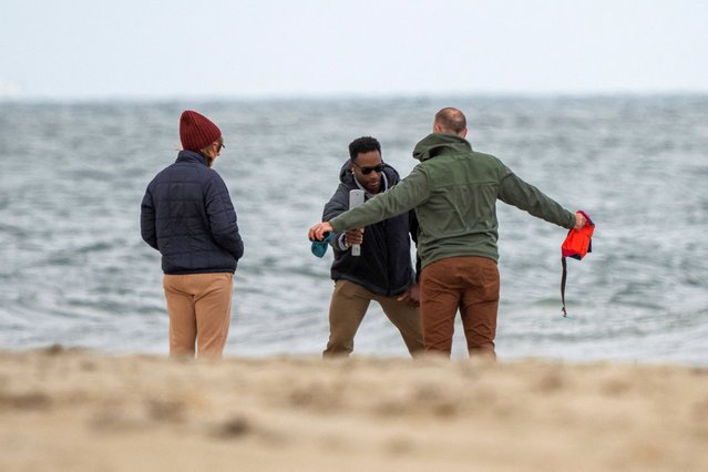 Civilians walking on the beach get screened by the U.S. Secret Service as President Joe Biden and first lady Jill Biden walk on the seashore in Rehoboth Beach, Delaware on November 10, 2024. (Photo by Ken Cedeno/Reuters)