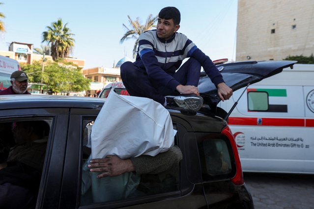 A mourner reacts atop a car as Palestinians transport the body of a child killed in an Israeli strike, amid the Israel-Hamas conflict, in Deir Al-Balah in the central Gaza Strip on December 4, 2024. (Photo by Ramadan Abed/Reuters)