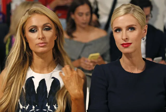 Paris Hilton, left, and her sister Nicky Hilton Rothschild await the start of the Oscar de la Renta Spring/Summer 2018 fashion show during Fashion Week, Monday, September 11, 2017, in New York. (Photo by Kathy Willens/AP Photo)