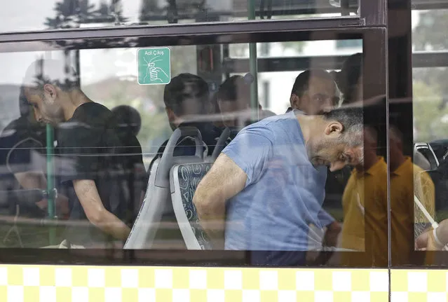 Turkish plain cloth policemen accompany detainee soldiers the 15 July failed coup attempt at a bus as they arrive to Istanbul court, in Istanbul, Turkey, 20 July 2016. Turkish Muslim cleric Fethullah Gulen, living in self-imposed exile in the USA, has been accused by Turkish President Recept Tayyip Erdogan of allegedly orchestrating the 15 July failed coup attempt. At least 290 people were killed and almost 1,500 injured amid violent clashes on July 15 as certain military factions attempted to stage a coup d'etat. (Photo by Sedat Suna/EPA)