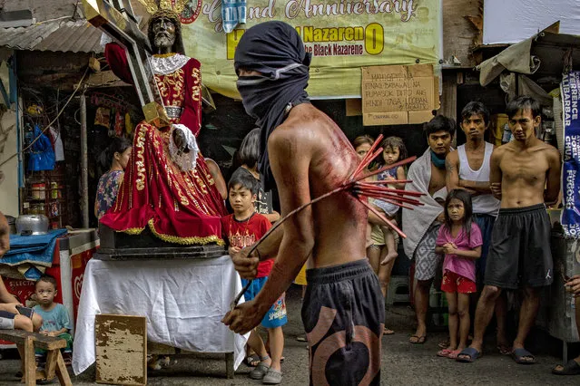 A flagellant whips his bloodied back along a street as penance, defying government orders to avoid religious gatherings and stay home to curb the spread of the coronavirus, as he commemorates Good Friday on April 10, 2020 in Manila, Philippines. Good Friday is a Christian holiday commemorating the crucifixion of Jesus and his death at Calvary. It is observed during Holy Week on the Friday preceding Easter Sunday. Most Easter celebrations in the Philippines have been cancelled after religious gatherings have been banned as part of government lockdown measures imposed on the country's main island Luzon to curb the spread of the coronavirus. Land, sea, and air travel has been suspended, while government work, schools, businesses, and public transportation have been ordered shut in a bid to keep some 55 million people at home. The Philippines' Department of Health has so far confirmed 4,076 cases of the new coronavirus in the country, with at least 203 recorded fatalities. The Philippines is the only Roman Catholic majority in Southeast Asia with around 85% practicing the faith. (Photo by Ezra Acayan/Getty Images)